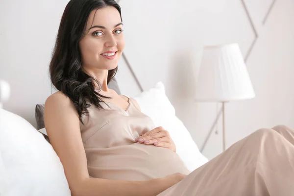 Beautiful young pregnant woman in bedroom — Stock Photo, Image