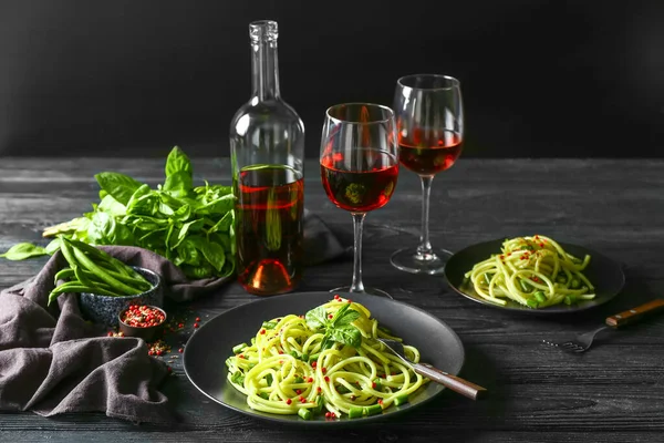 Tasty pasta with wine on dark table — Stock Photo, Image