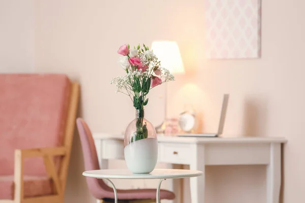 Beautiful flowers in vase on table in room — Stock Photo, Image