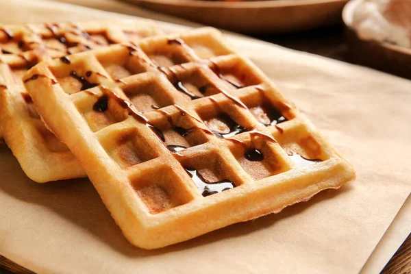 Tasty waffles with chocolate on table, closeup — Stock Photo, Image