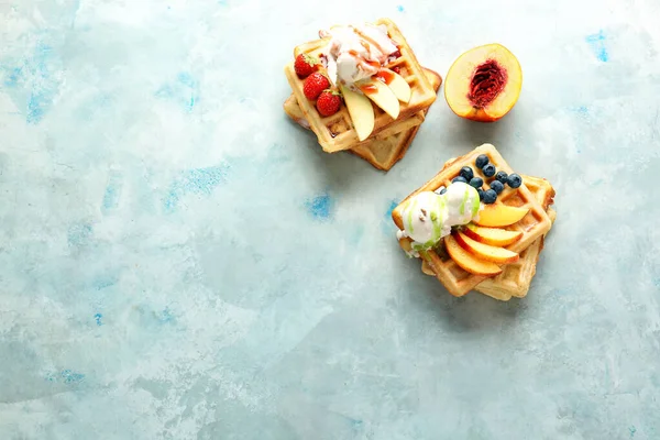 Tasty waffles with fruits, berries and ice-cream on color background — Stock Photo, Image