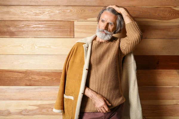 Portrait of stylish senior man on wooden background — Stock Photo, Image