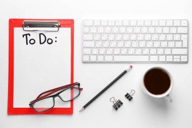 Empty to do list, PC keyboard, cup of coffee and pencil on white background