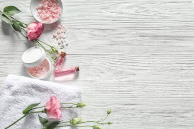 Composition with cosmetics for spa procedures on wooden background