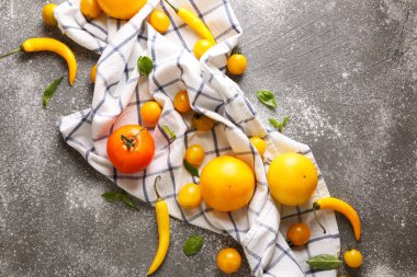 Gri masada taze domates ve kırmızı biber.