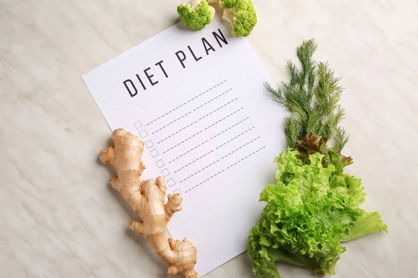 Sheet of paper with diet plan and healthy products on white background — Stock Photo, Image