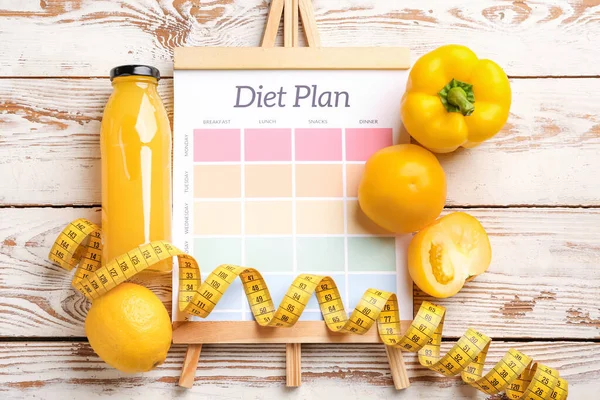 Sheet of paper with diet plan, measuring tape and healthy products on white wooden background — Stock Photo, Image