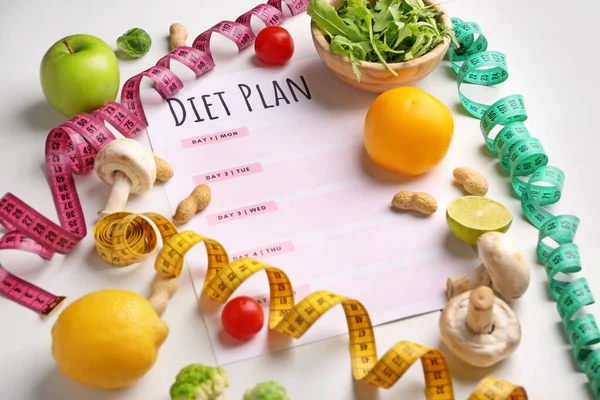 Sheet of paper with diet plan, measuring tapes and healthy products on white background — Stock Photo, Image