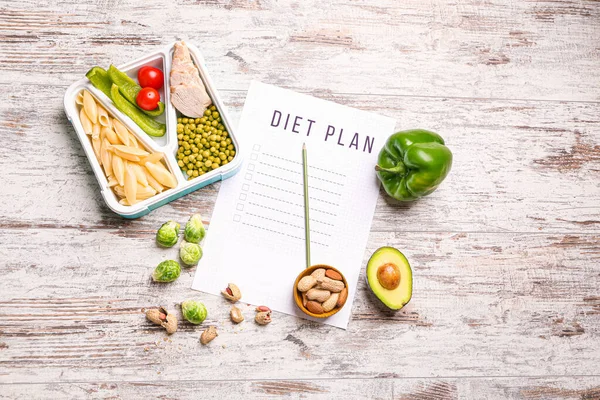 Sheet of paper with diet plan and healthy food on white wooden background — Stock Photo, Image