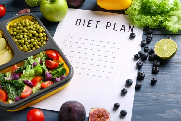Sheet of paper with diet plan and healthy products on wooden table — Stock Photo, Image