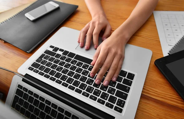 Young woman working on laptop at table — Stock Photo, Image