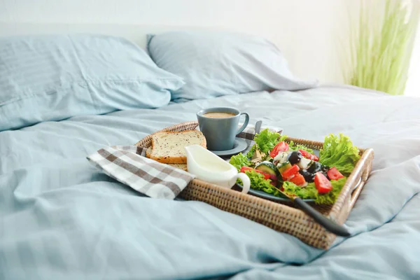 Tray with tasty breakfast on bed — Stock Photo, Image