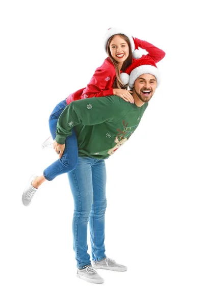 Happy young couple in Christmas clothes on white background — Stock Photo, Image