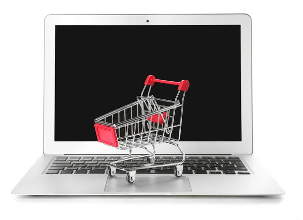 Laptop and small cart on white background. Internet shopping concept — Stock Photo, Image