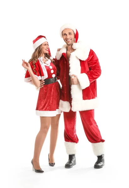 Young couple dressed as Santa Claus on white background — ストック写真