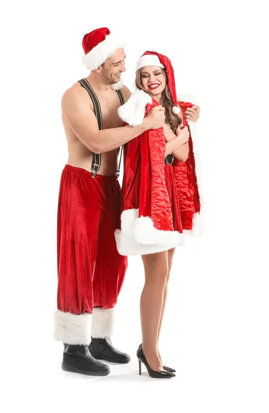 Young couple dressed as Santa Claus on white background — ストック写真