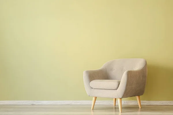 Stylish armchair near color wall in room — Stock Photo, Image