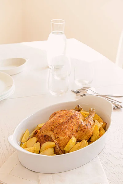 Baking dish with tasty chicken and potato served on table — Stock Photo, Image