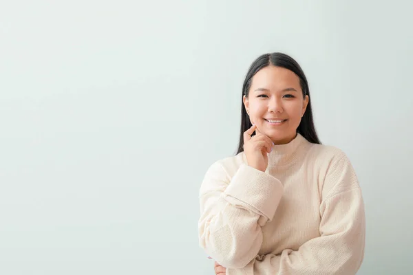 Portrait of beautiful Asian woman on light background — Stock Photo, Image