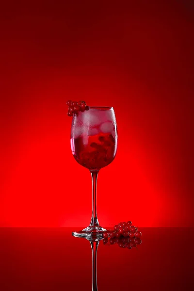Glass of tasty cocktail on dark color background — Stock Photo, Image