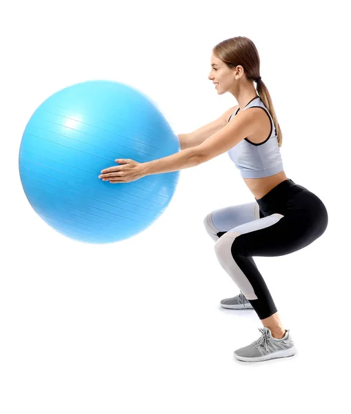 Sporty young woman training with fitball against white background — ストック写真
