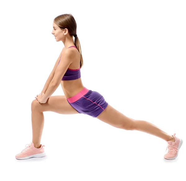 Sporty young woman training against white background — Stock Photo, Image