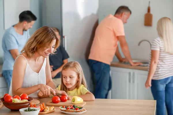 Mother with little daughter cooking in kitchen — Stock Photo, Image