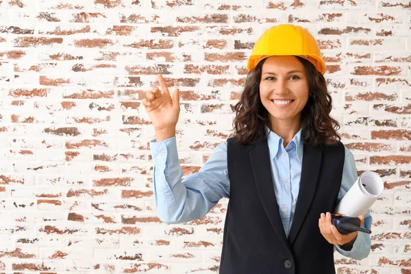 Portrait of female architect against brick wall — Stock Photo, Image