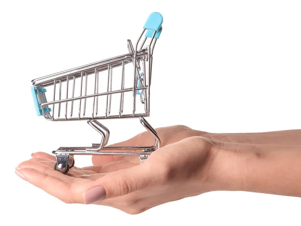 Female hands with small empty shopping cart on white background — Stock Photo, Image