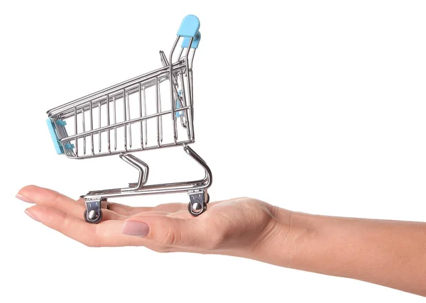 Female hand with small empty shopping cart on white background — Stock Photo, Image