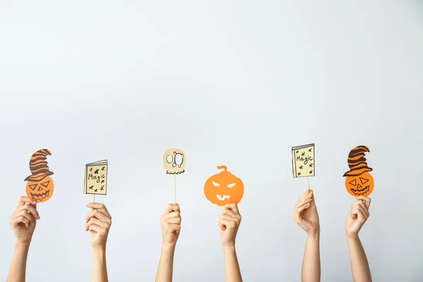 Many hands with Halloween decor on light background — Stock Photo, Image