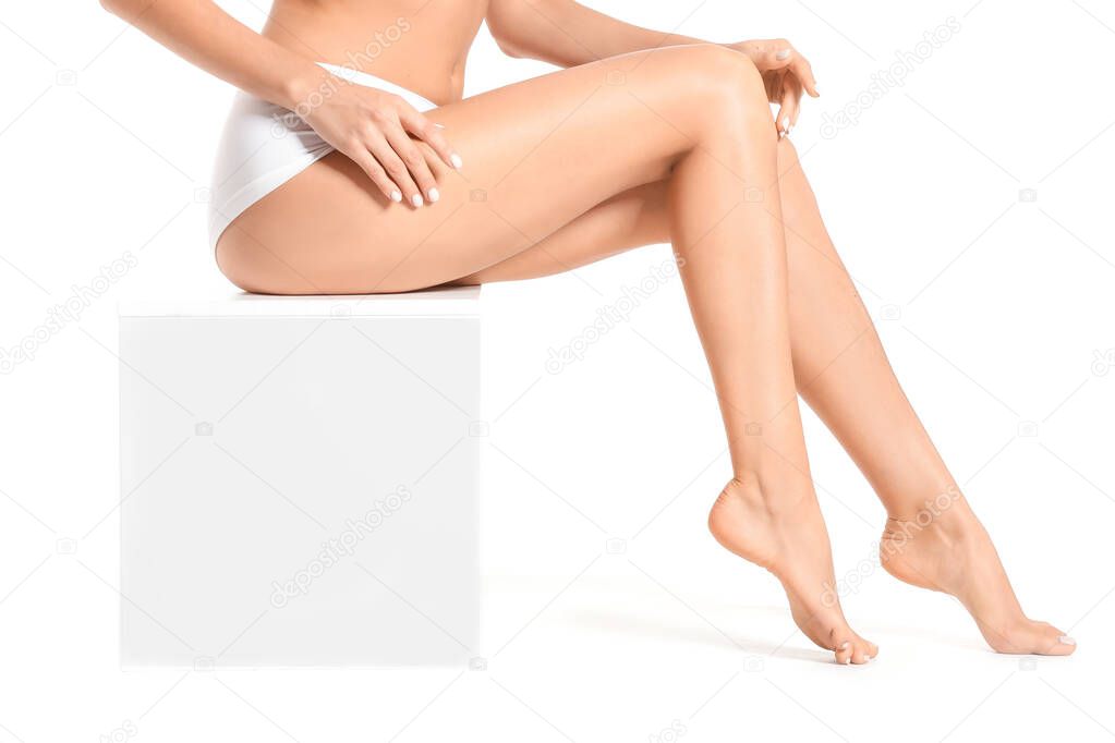 Woman with beautiful legs after depilation on white background