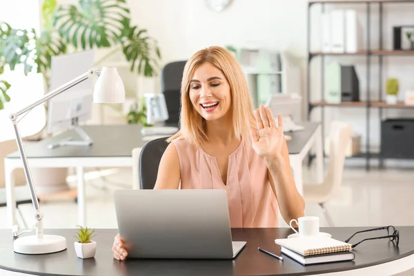 Beautiful businesswoman working on laptop in office — Stock Photo, Image