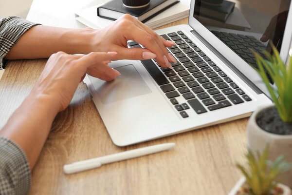 Young woman working on laptop at table