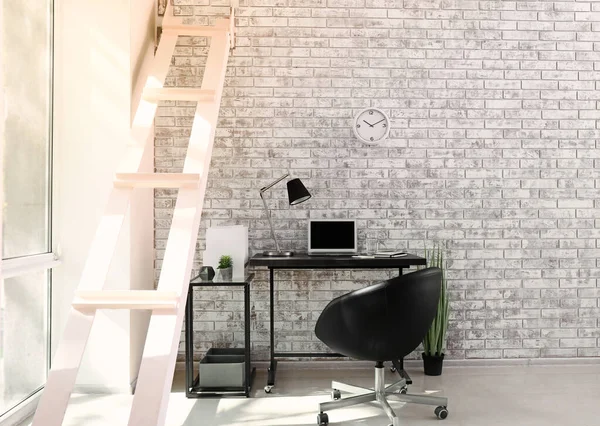 Comfortable workplace near light brick wall — Stock Photo, Image
