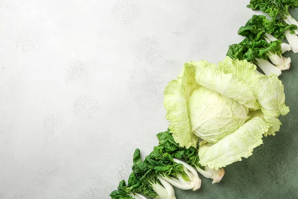 Different fresh cabbage on light background — Stock Photo, Image