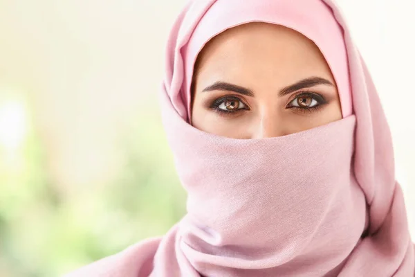 Portrait of beautiful Muslim woman on blurred background — Stock Photo, Image