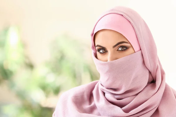 Portrait of beautiful Muslim woman on blurred background — Stock Photo, Image