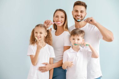 Aile portresi, arka planda diş fırçalama.