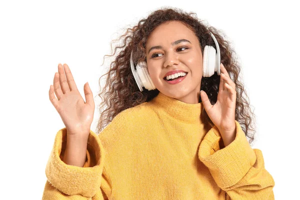 Beautiful African-American woman listening to music on white background — Stock Photo, Image