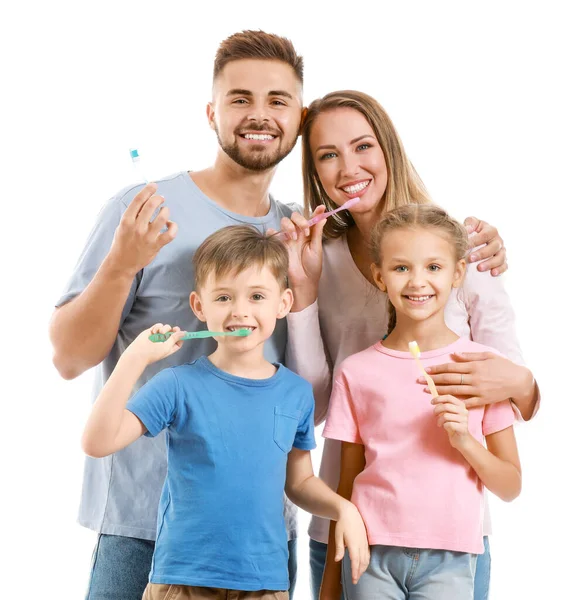 Portrait of family with toothbrushes on white background — ストック写真
