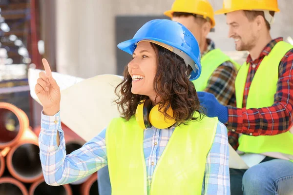 Portrait of female architect and her team in building area — Stock Photo, Image