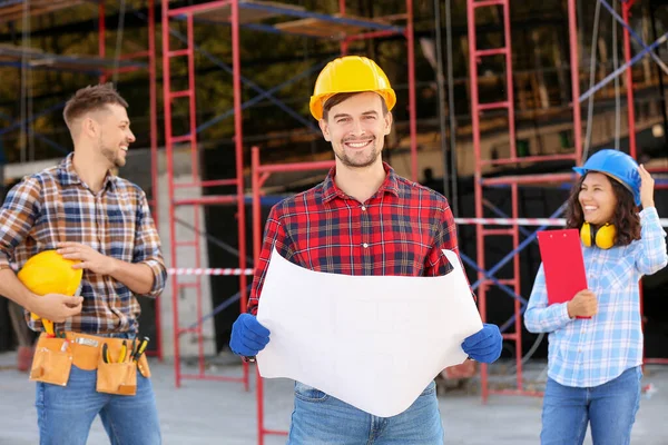 Portrait of male architect with his team in building area — Stock Photo, Image