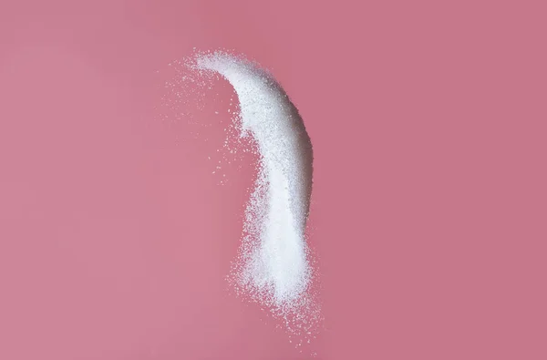 Throwing of sand sugar against color background — ストック写真