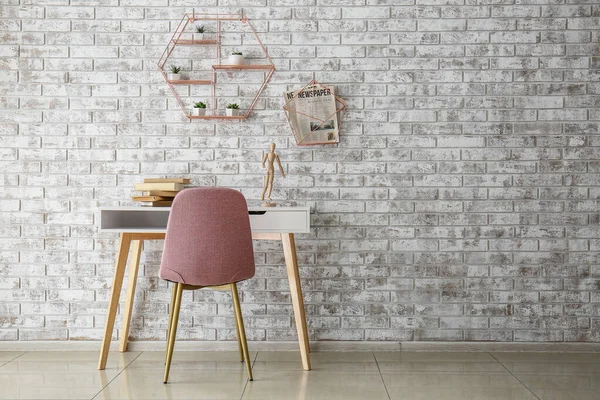 Table with chair near brick wall — Stock Photo, Image