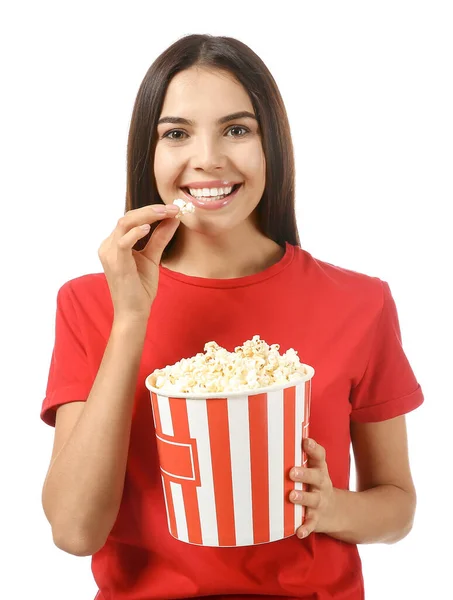 Young woman eating popcorn on white background — Stock Photo, Image