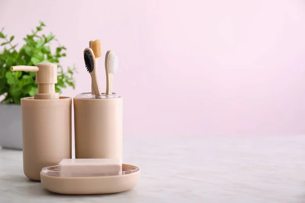 Toothbrushes with soap on table in bathroom — Stock Photo, Image