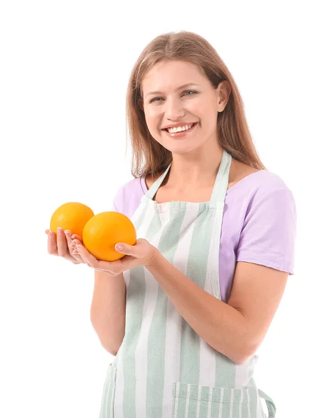 Beautiful young woman in apron and with oranges on white background — Stock Photo, Image