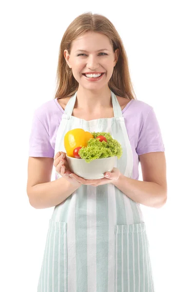 Belle jeune femme en tablier et avec des légumes sur fond blanc — Photo