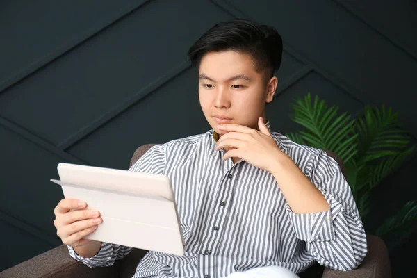 Asian man with tablet computer at home — Stock Photo, Image